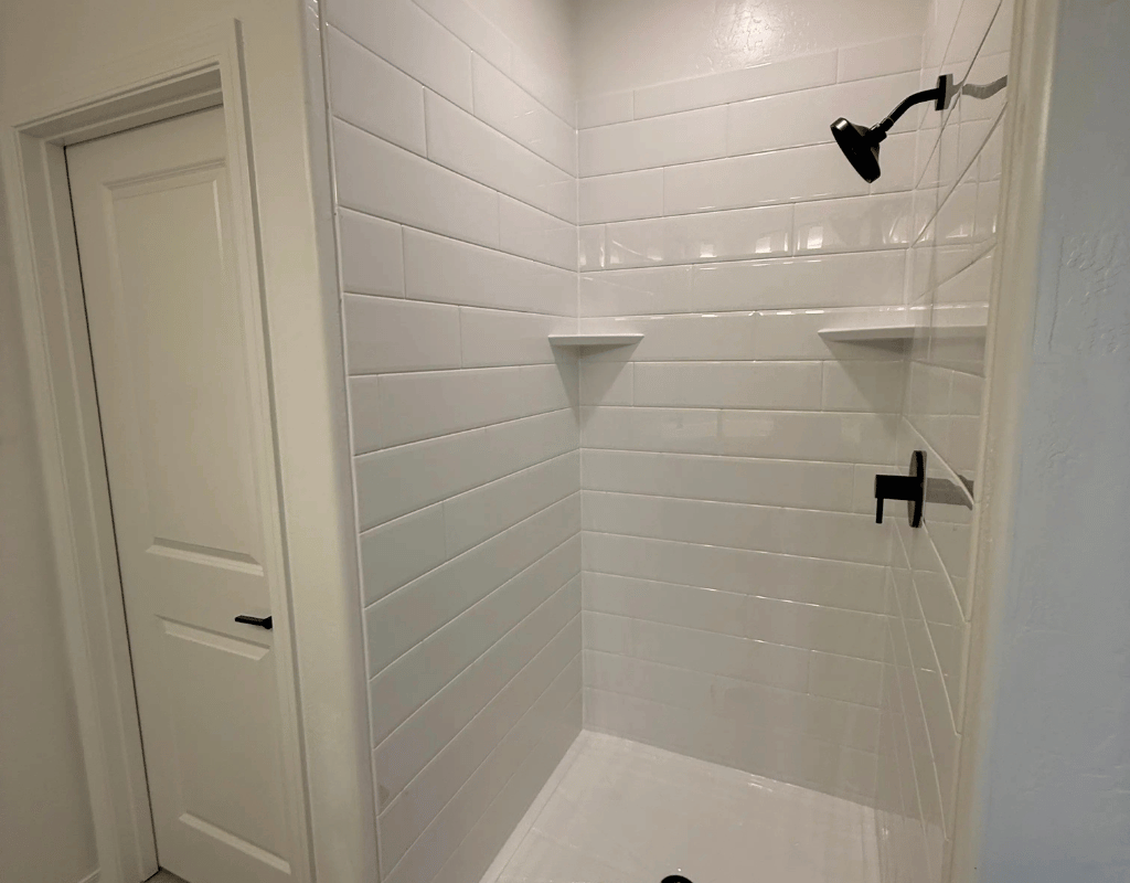Completed bathroom remodeling project with freestanding tub and walk-in shower by Rapid Remodel