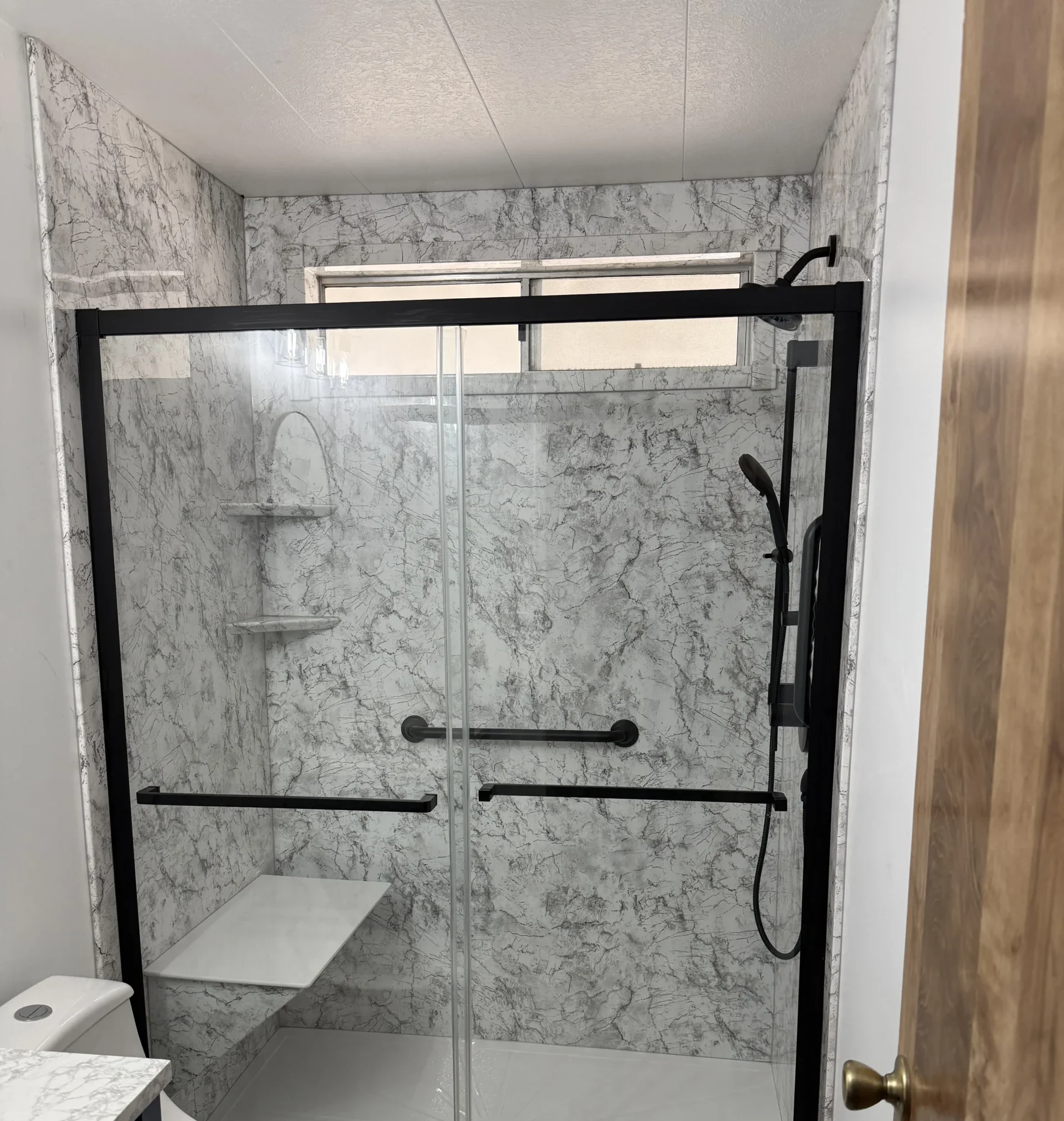 Rapid Remodel team completing a bathroom remodeling project with updated shower tile