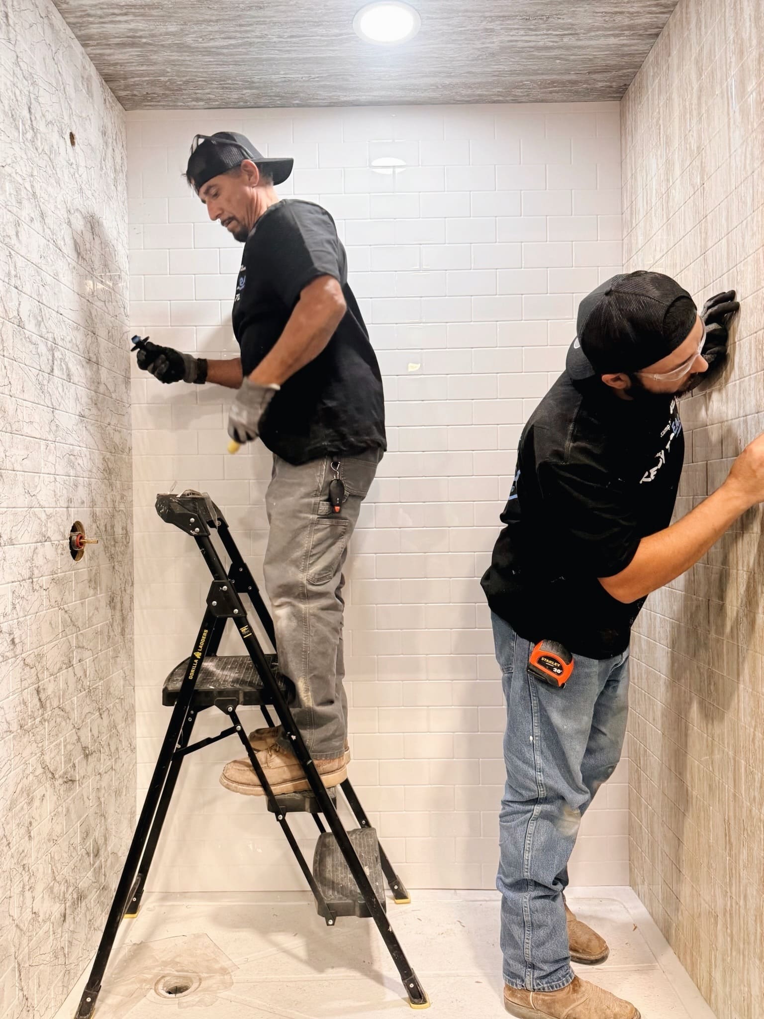 Rapid Remodel contractors completing shower remodeling and wall panel installation
