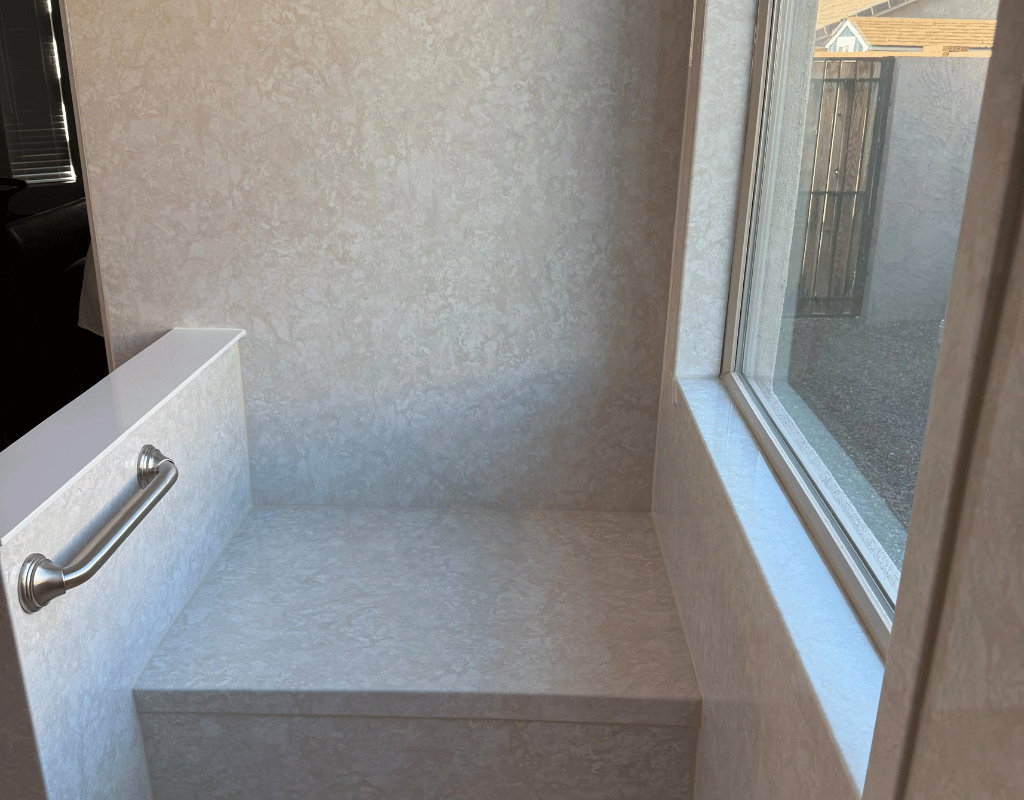 Completed custom shower remodel with clean wall panels, grab bars, and a modern walk-in design