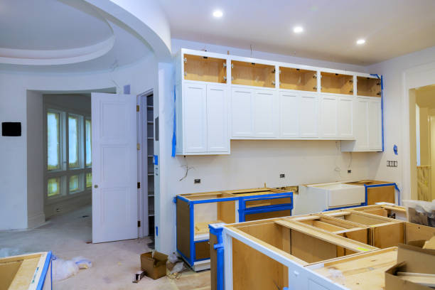 Contractor reviewing Kitchen Remodeling measurements inside a Mission Viejo - CA home before cabinet installation