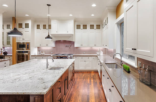 Homeowner reviewing cabinet samples and stone slabs during upscale coastal kitchen renovation