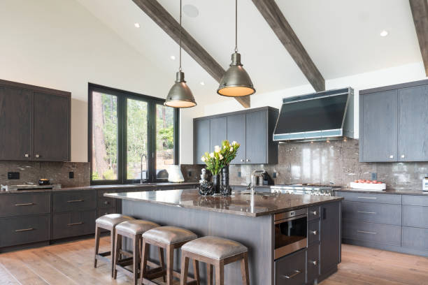 Skilled remodel professional assessing kitchen materials and layout in coastal home setting