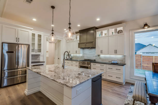 Homeowner comparing tile, cabinet, and countertop samples during coastal kitchen redesign